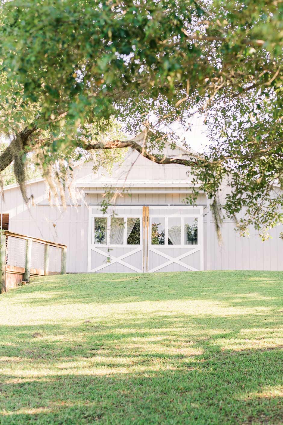 The white boathouse wedding venue at Up the Creek Farms in Melbourne, FL.